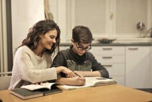 Parent helping child with homework at home